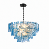A modern multi-light chandelier featuring textured, irregularly shaped translucent blue glass shades suspended from a black metal frame and chain.