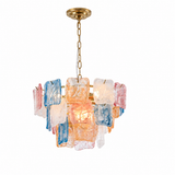 A modern multi-light chandelier featuring a gold-finished ceiling canopy and chain, with multiple rectangular glass shades in translucent white, blue, and pink, illuminated from within.