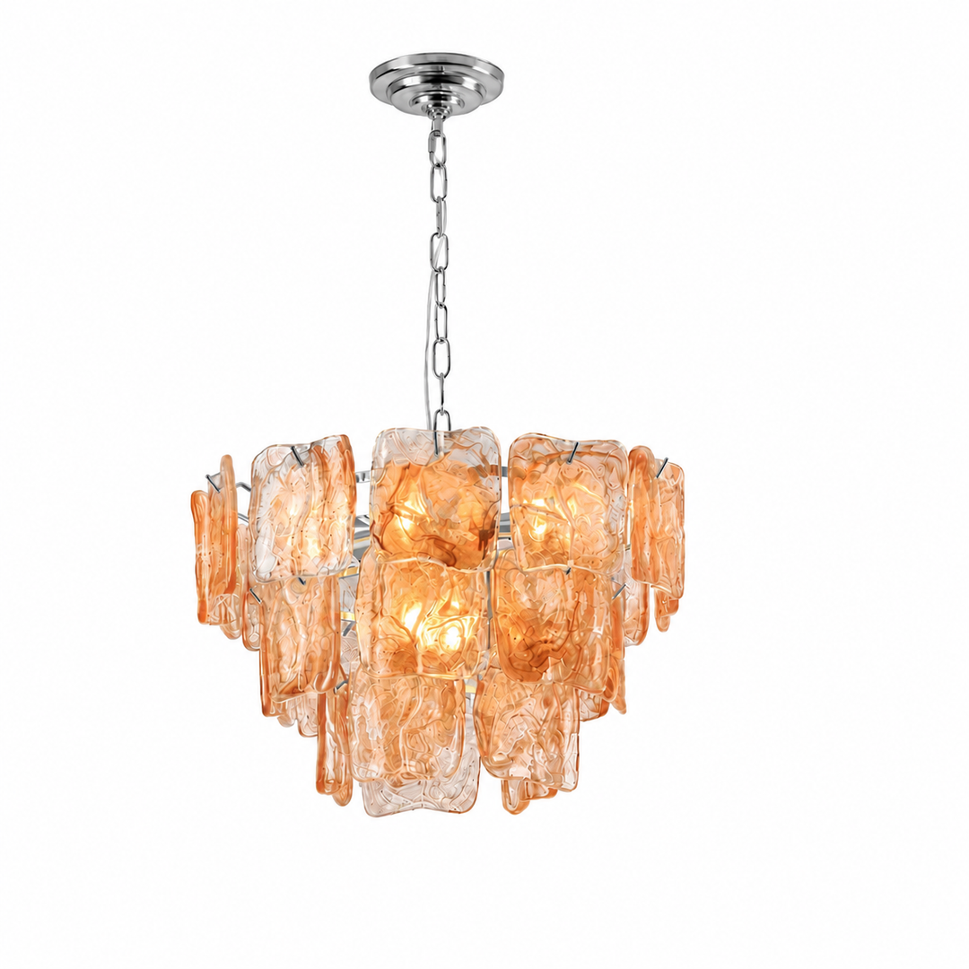 A modern multi-light chandelier featuring textured, warm amber-orange glass blocks suspended from a polished silver-tone metal chain and canopy, shown against a plain white background.