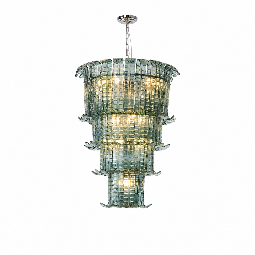 A tiered glass chandelier with a silver metal canopy and chain, featuring multiple levels of textured, translucent green-tinted glass panels that glow with warm light, shown against a plain white background.