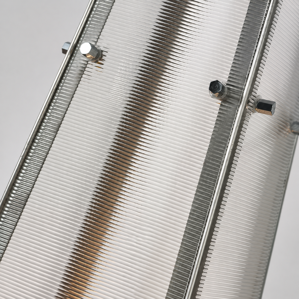 Close-up of the floor lamp’s clear ribbed acrylic shade, silver metal frame, and exposed fasteners against a light gray background.