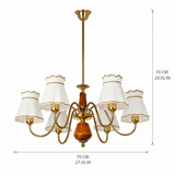 A six-light brass chandelier with white pleated drum shades and a central amber glass orb, shown with dimension lines indicating 70 cm width and 76 cm height on a white background.