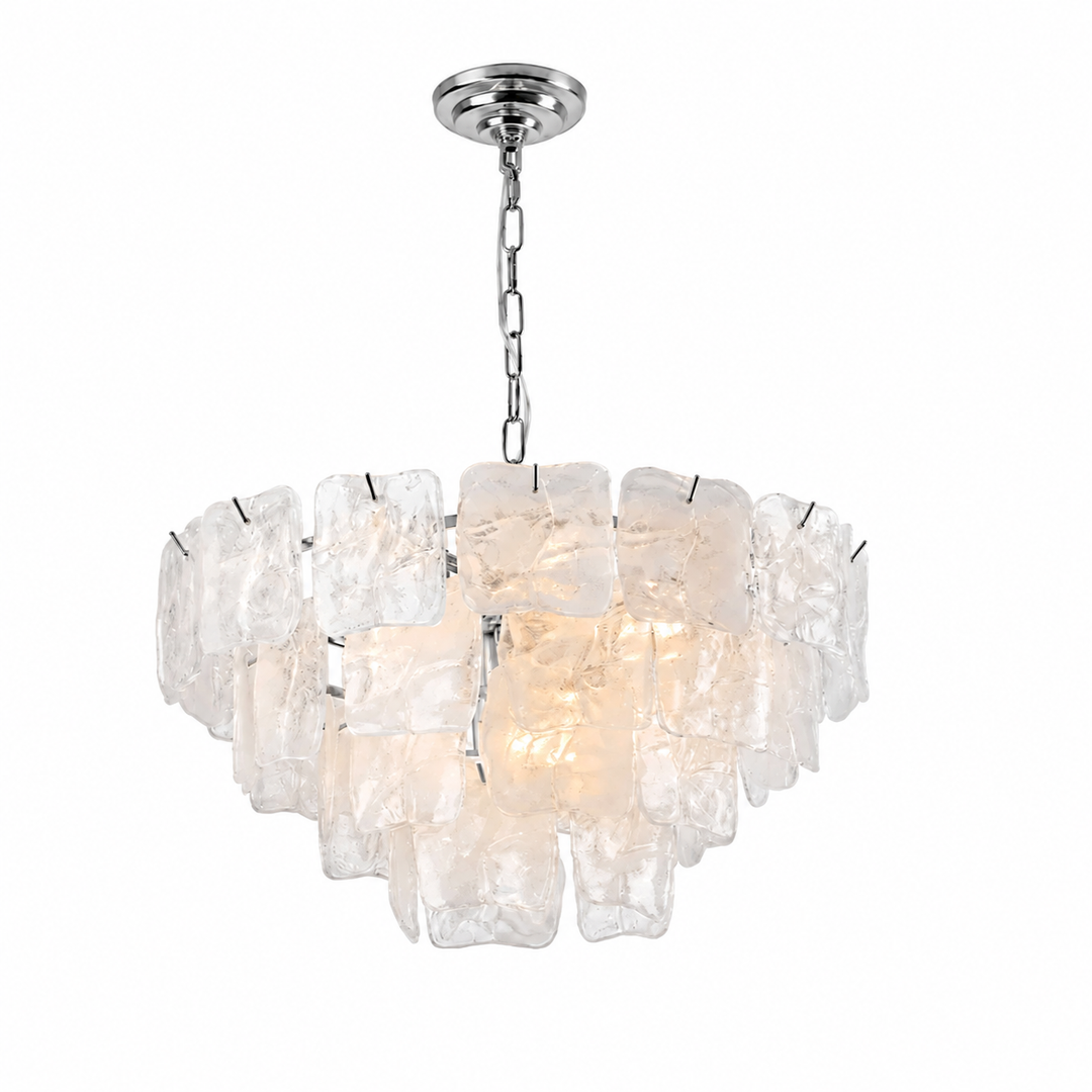 A modern multi-light chandelier featuring irregular, textured clear glass or acrylic blocks suspended in a tiered arrangement, with a polished silver metal chain and canopy, shown against a plain white background.