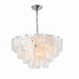 A modern multi-light chandelier featuring irregular, textured clear glass or acrylic blocks suspended in a tiered arrangement, with a polished silver metal chain and canopy, shown against a plain white background.