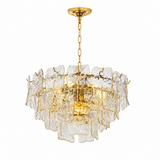 A modern multi-light pendant chandelier featuring clear, irregular textured glass panels held by a brushed gold metal frame, suspended from a matching gold ceiling canopy with a chain.