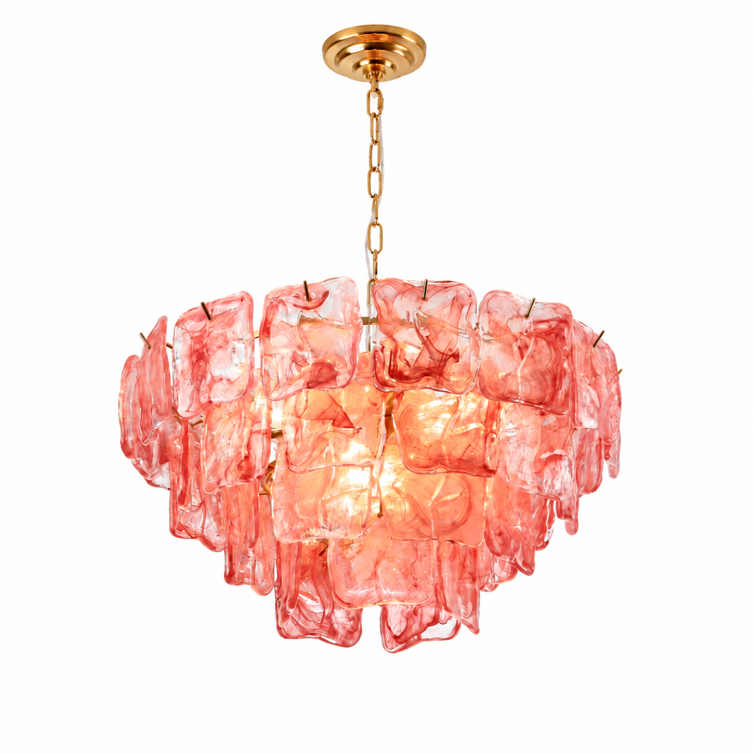 A modern drum-shaped pendant chandelier featuring textured, translucent pink glass discs that glow warmly from an integrated light, suspended from a polished gold-toned chain and ceiling canopy against a solid white background.