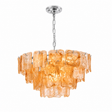 A modern multi-light pendant chandelier featuring textured amber-orange glass disc shades suspended from a polished silver-tone metal chain and canopy, shown against a plain white background.