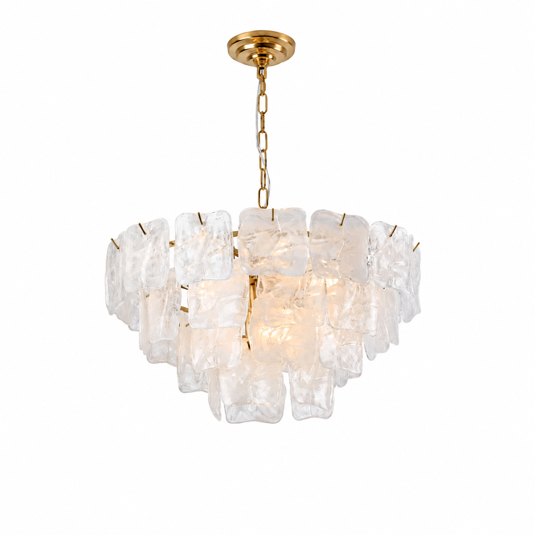A modern multi-light chandelier featuring clear, irregularly shaped ice-like glass blocks suspended in a tiered circular arrangement, with a polished gold brass chain and ceiling canopy, shown against a solid white background.