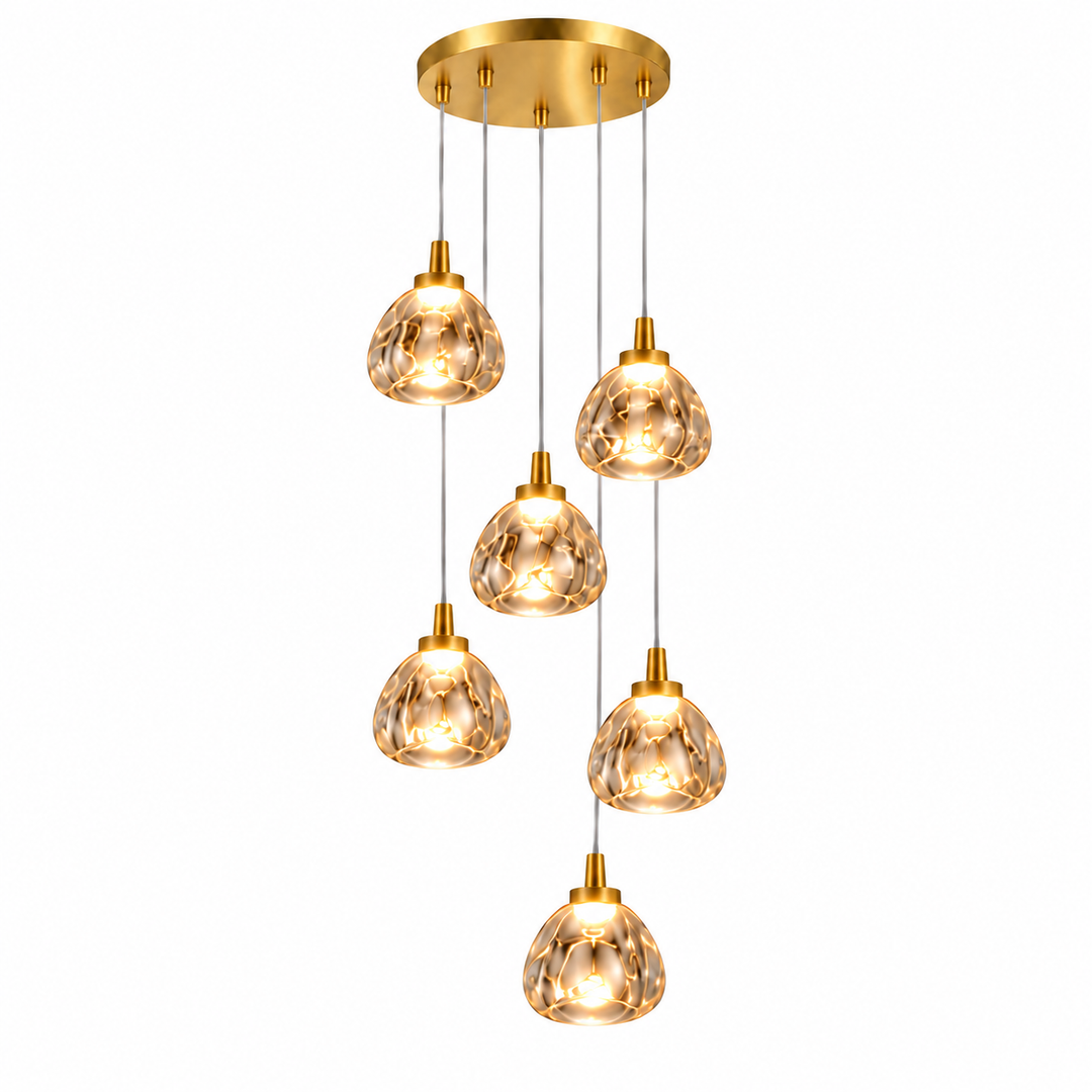 A modern multi-light linear pendant chandelier with five cascading clear glass teardrop shades and a brushed gold ceiling canopy, shown against a solid white background.
