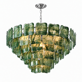 A modern multi-tier chandelier featuring textured green and amber glass panels suspended in a circular arrangement, with a polished silver metal chain and ceiling canopy, shown against a plain white background.