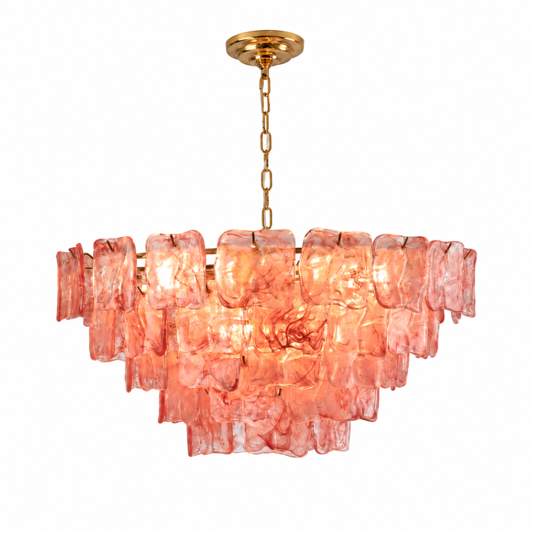A modern tiered chandelier featuring textured, translucent pink glass blocks suspended from a brushed gold brass rod and chain.