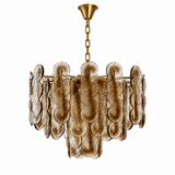 A modern tiered chandelier featuring textured, scalloped glass disc elements in a warm bronze and gold finish, suspended from a matching gold-toned chain and canopy against a solid white background.