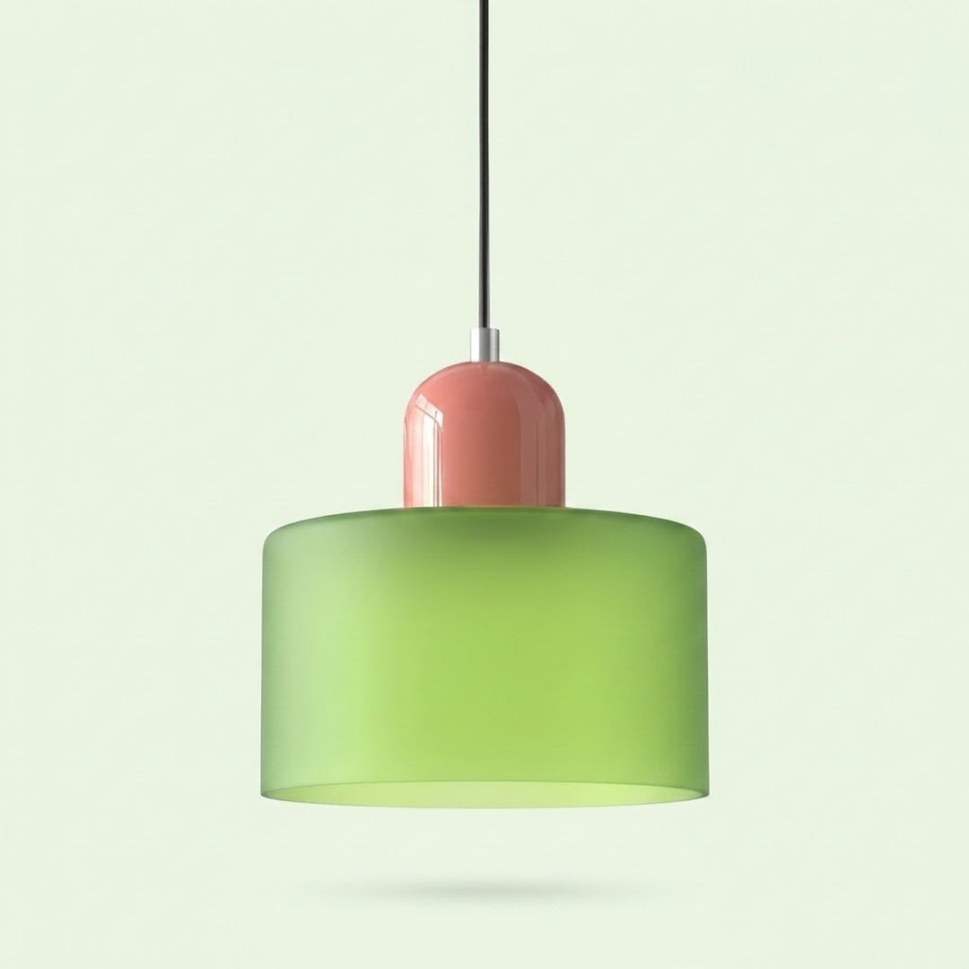 A chandelier with a light green glass drum shade and glossy pink cap hangs against a pale green background.