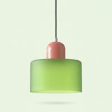 A chandelier with a light green glass drum shade and glossy pink cap hangs against a pale green background.