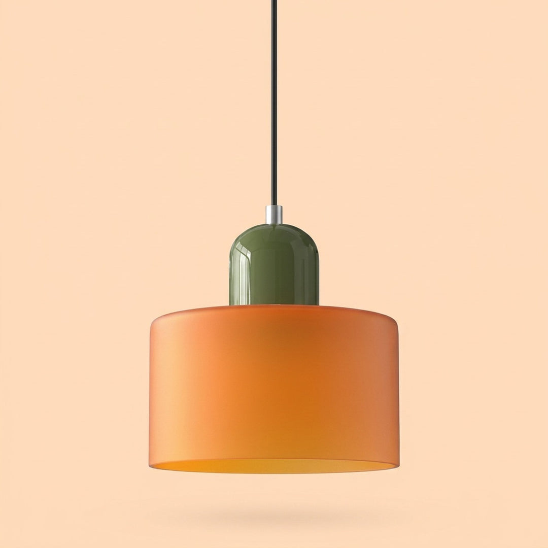 A chandelier with an orange glass drum shade and glossy olive green cap hangs against a peach background.
