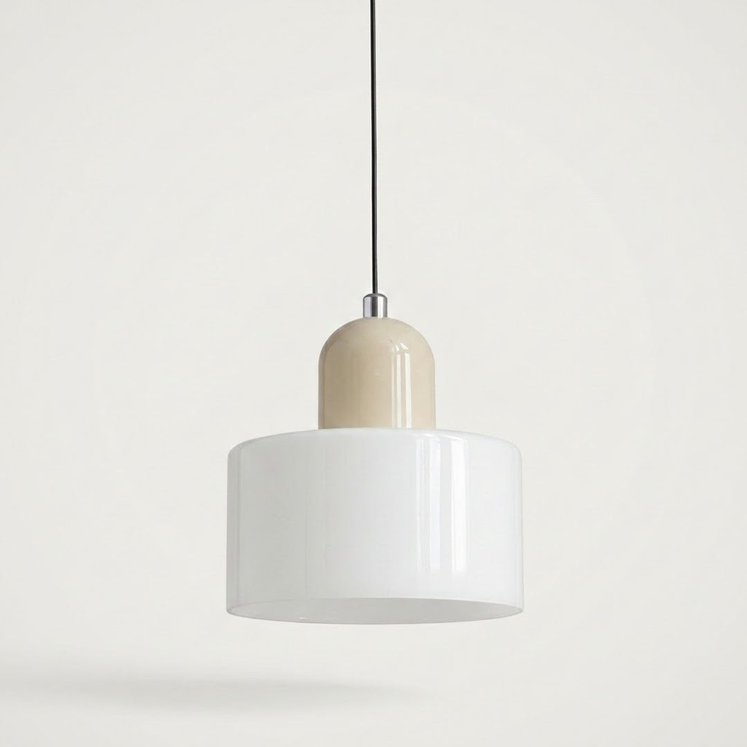 A chandelier with a white glass drum shade and rounded beige cap hangs from a black cord against a pale background.