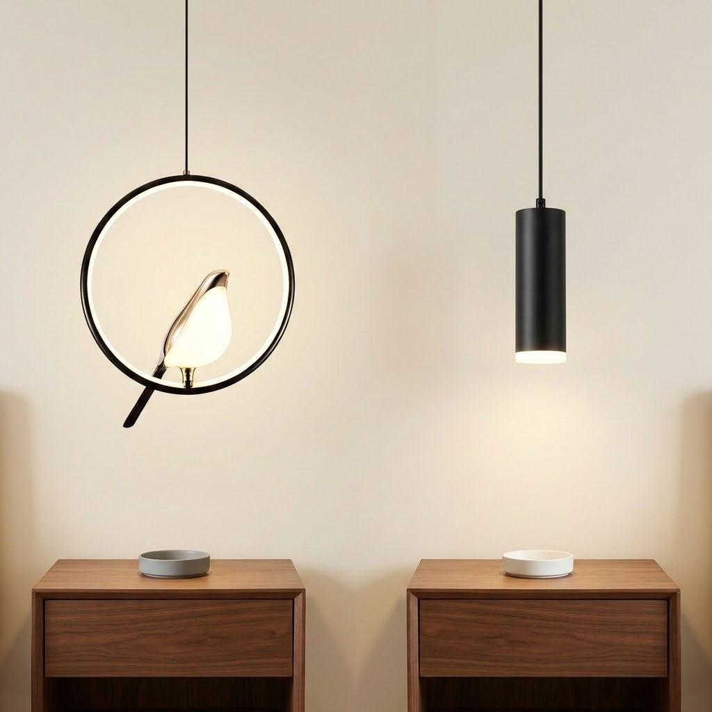 Two modern pendant lights hanging above two wooden nightstands against a beige wall. The left light has a circular black frame with a bird-shaped bulb, and the right light has a simple black cylindrical shade.