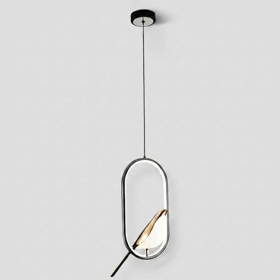 A modern pendant light with a black circular ceiling canopy, a thin black cord, and an oval frame with a gold-toned leaf-shaped shade inside, shown against a light gray background.