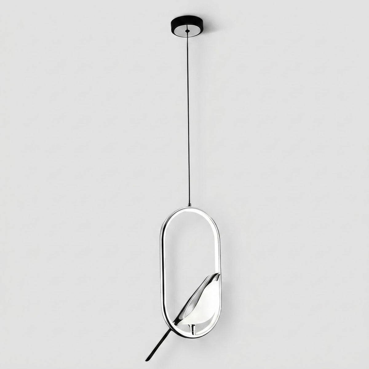 A modern pendant light fixture with a thin black suspension cord, a circular black ceiling canopy, and a polished silver-toned oval frame holding a white leaf-shaped glass shade, shown against a light gray background.