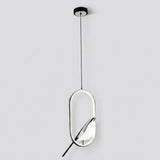 A modern pendant light fixture with a sleek oval frame, featuring a black ceiling canopy, a thin black suspension cord, and a reflective silver and black geometric body against a light gray background.