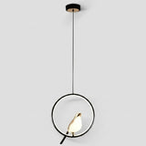 Modern pendant light fixture with a black circular ring, black cord, and a warm glowing white and gold leaf-shaped bulb, shown against a light gray background.
