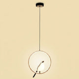 A modern pendant light with a circular white glass shade, a thin gold-toned metal frame, and a black hanging rod and canopy, shown against a solid beige background.