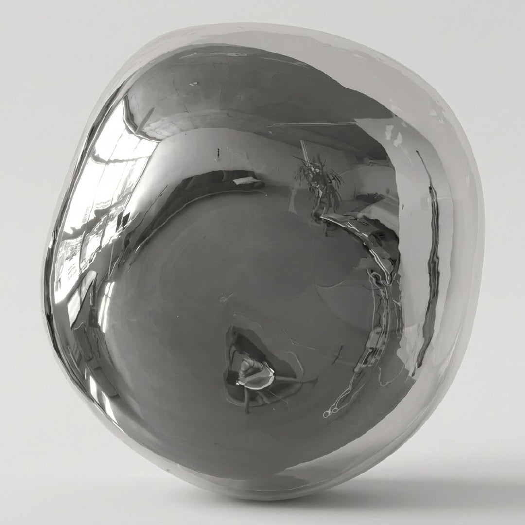 Chrome glass wall sconce with an irregular rounded shade and mirrorlike reflections against a light gray background.