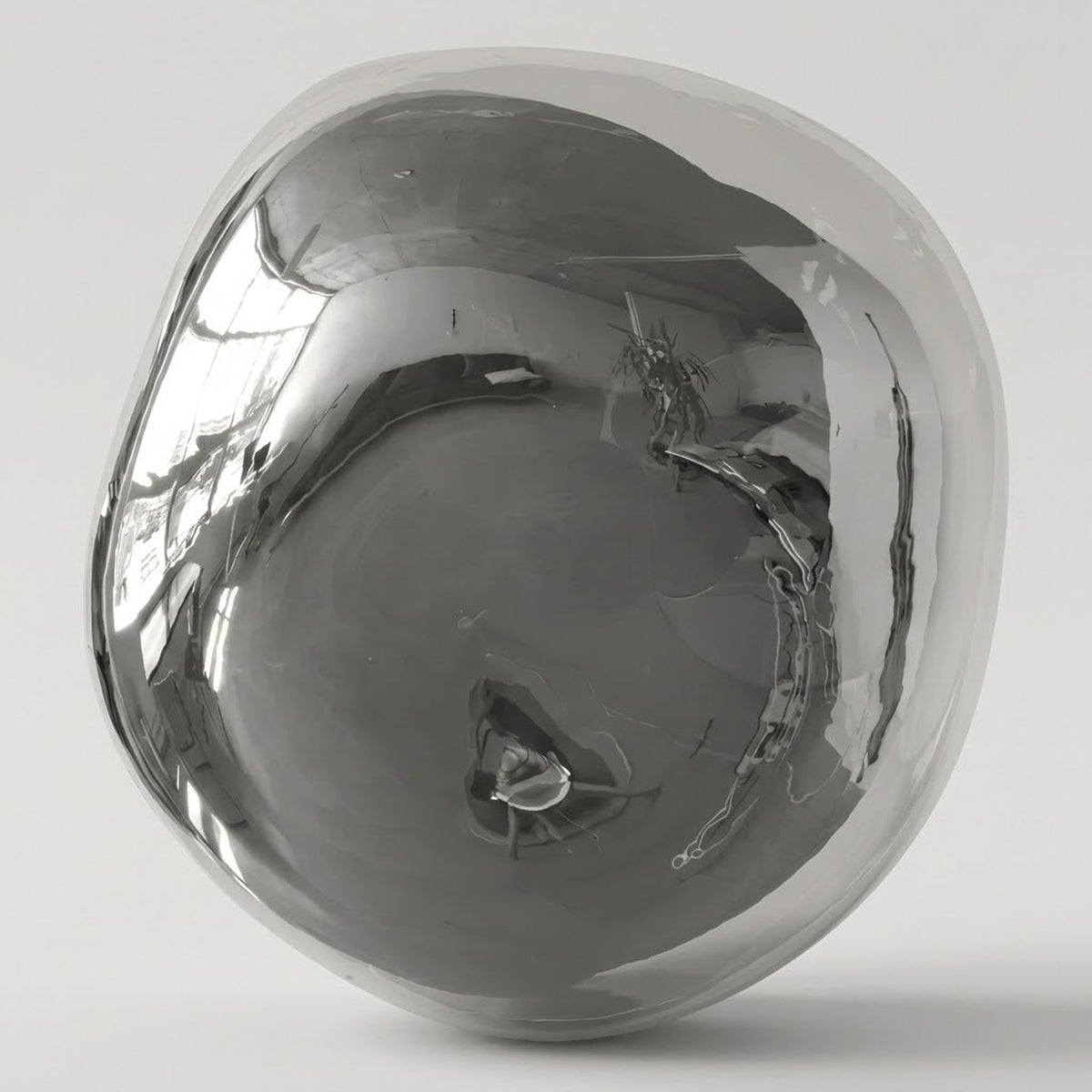 Chrome glass wall sconce with an irregular rounded shade and mirrorlike reflections against a light gray background.