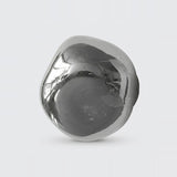 Chrome glass wall sconce with an asymmetrical rounded shade and dark mounting base visible behind it against a light gray background.