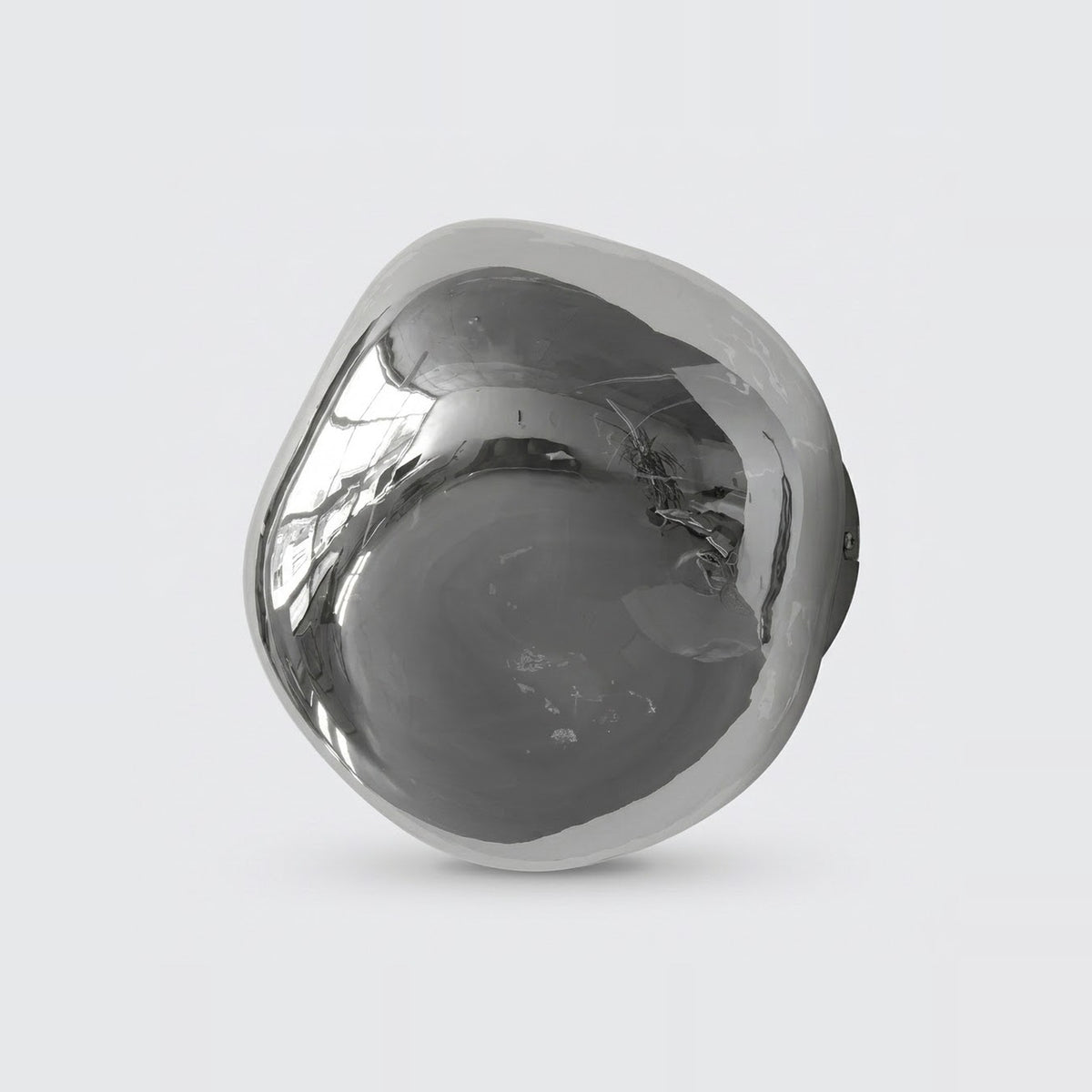 Chrome glass wall sconce with an asymmetrical rounded shade and dark mounting base visible behind it against a light gray background.