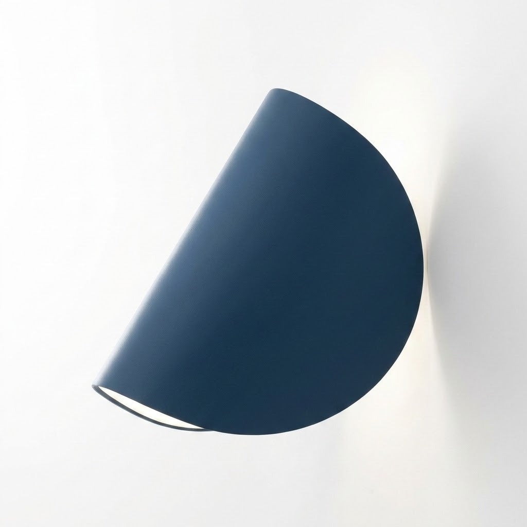 A modern semi-circular wall sconce in a matte dark blue finish, shown mounted on a plain white wall with a soft shadow.