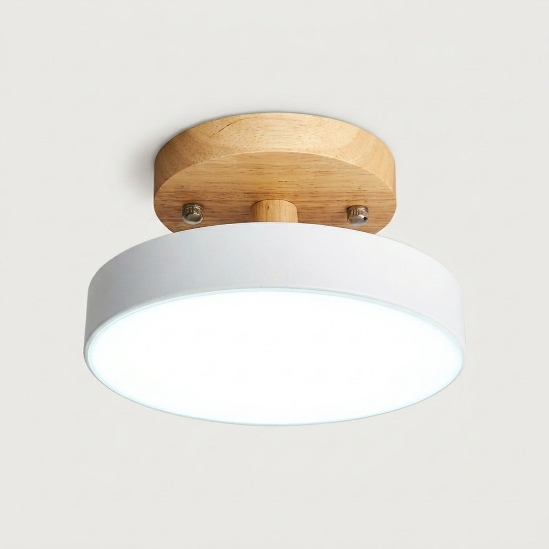 A modern semi-flush mount ceiling light featuring a white cylindrical shade and a natural wood circular ceiling mount, shown against a plain light gray background.