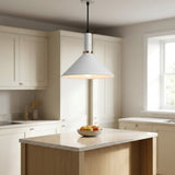 A modern white pendant light with a warm glowing shade hangs over a kitchen island in a bright, contemporary kitchen with cream cabinets and a light wood countertop.