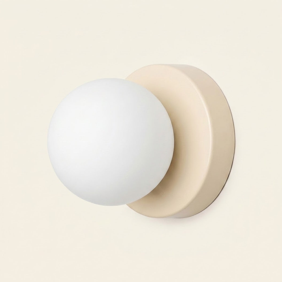 Wall sconce with a white plastic globe shade and beige circular iron base shown against a plain cream background.