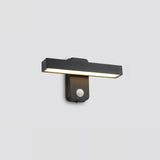 Black wall sconce with a horizontal light bar glowing warm white above a round motion sensor against a light gray background.