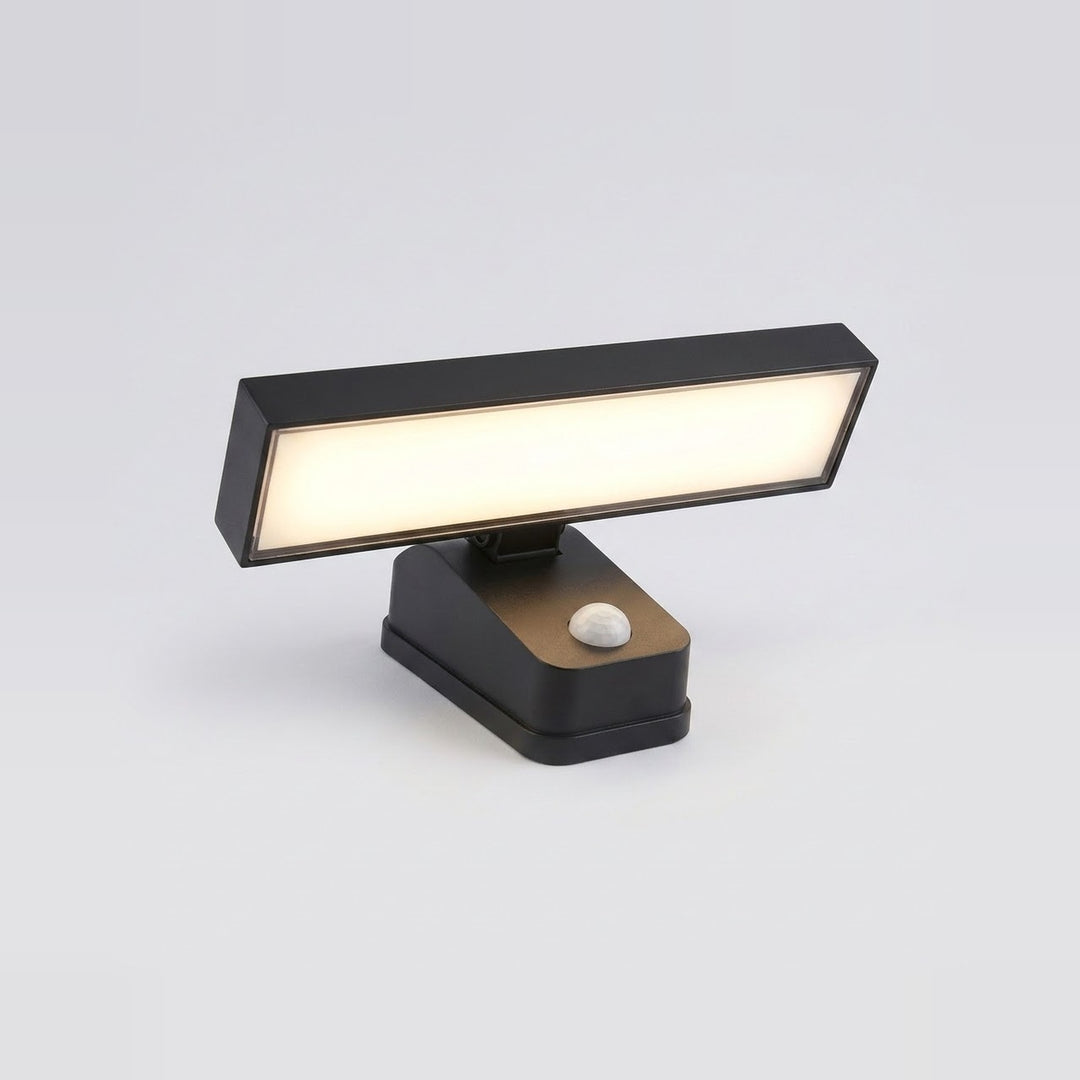 Black wall sconce with a broad illuminated rectangular panel and white motion sensor, shown at an angle against a light gray background.