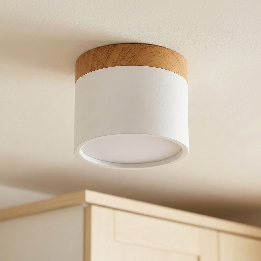 White LED downlight with wood trim and an unlit circular diffuser, mounted on a ceiling above cabinetry.