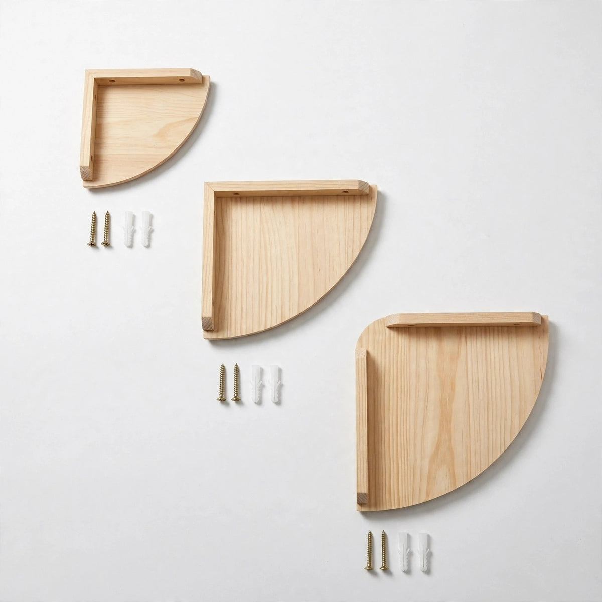 Three light natural pine quarter-round corner shelves in increasing sizes on a white background, each beside two gold screws and two white plugs.