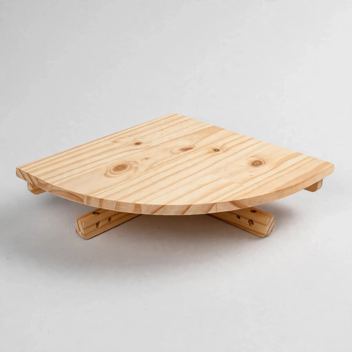 A single small light natural pine quarter-round corner shelf with visible knots and grain, resting on its cleats against a plain white background.