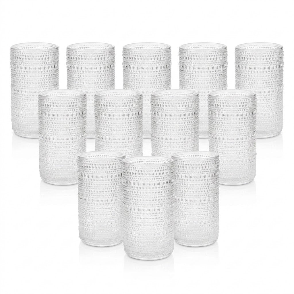 A set of 12 clear textured glass tumblers arranged in three rows of four on a white background.