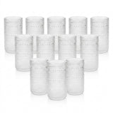 A set of 12 clear textured glass tumblers arranged in three rows of four on a white background.