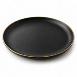 One matte black ceramic dinner plate with a thin gold rim isolated on a white background.