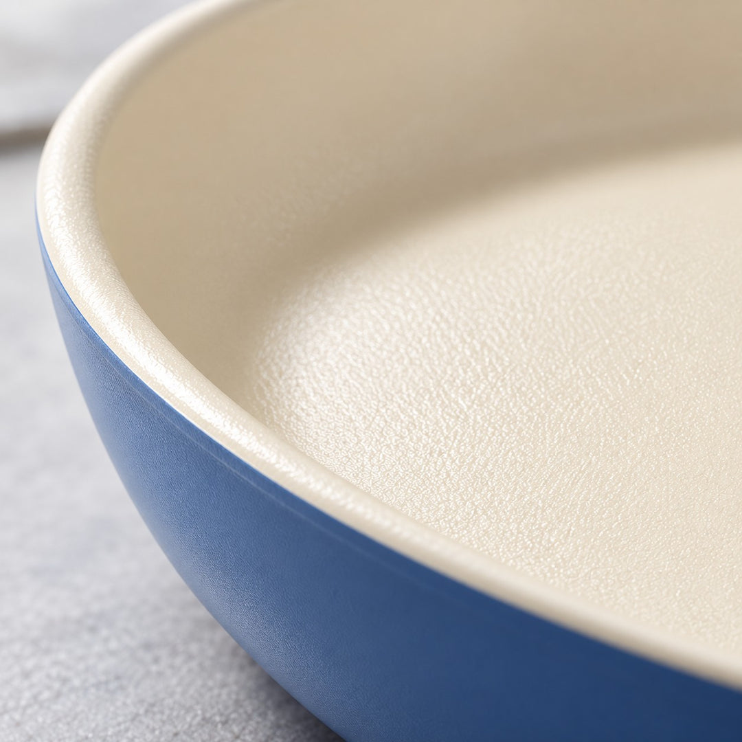 Slate Blue Ceramic Cookware Set shows the cream ceramic interior and slate blue finish in close detail.