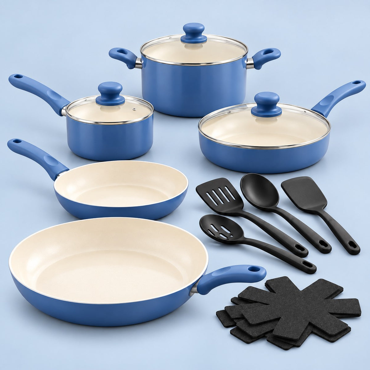 Slate Blue Ceramic Cookware Set is arranged with its glass lids, utensils, and protectors on a pale blue backdrop.