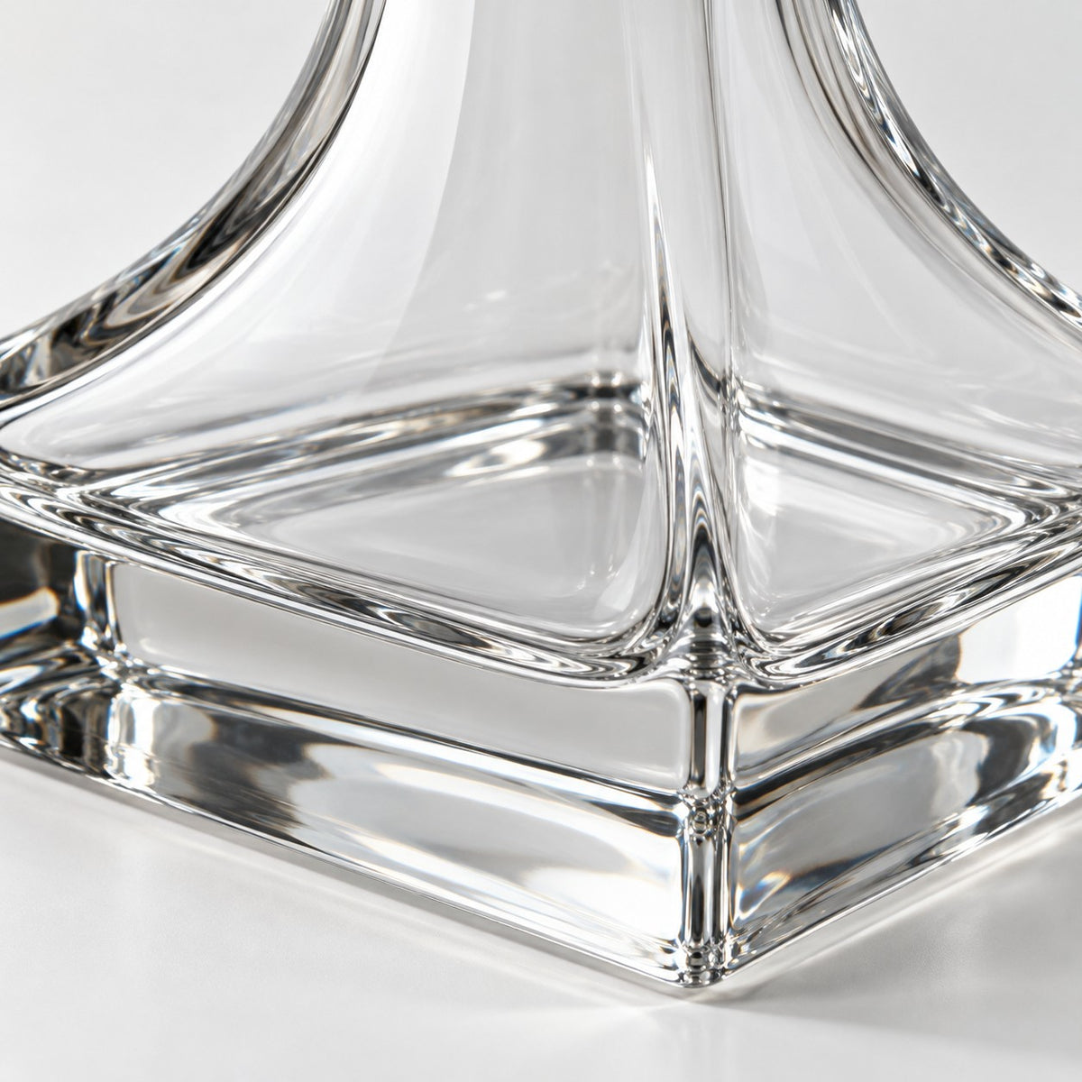 Close-up of the transparent thick glass and polished heavy base of the wine decanter.