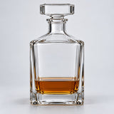 Smooth Square glass wine decanter with amber drink on a pale studio backdrop.