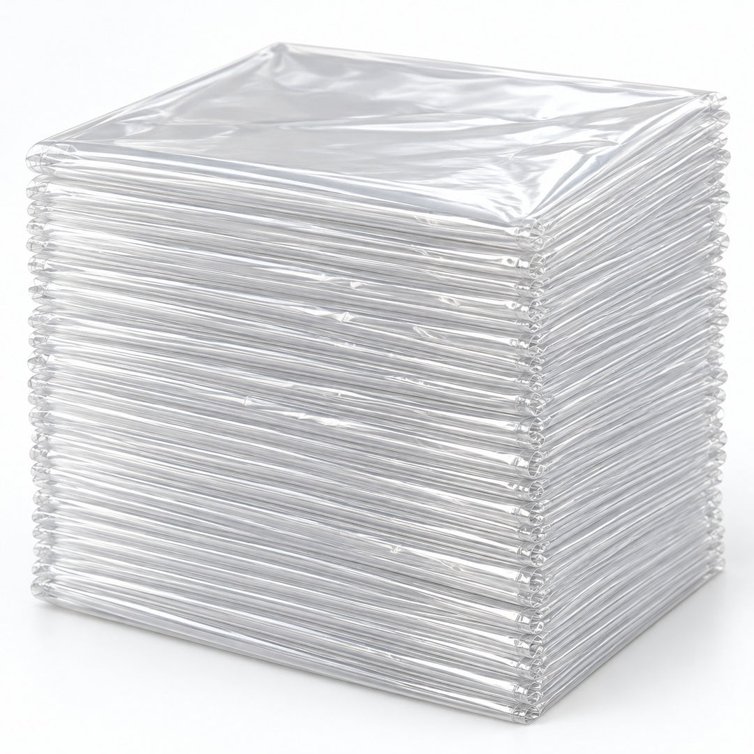 Set of 30 clear disposable plastic tablecloths folded in a thicker layered stack on a pale backdrop.