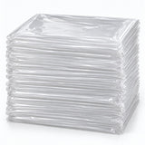 Set of 50 clear disposable plastic tablecloths folded in a substantial layered stack on a pale backdrop.
