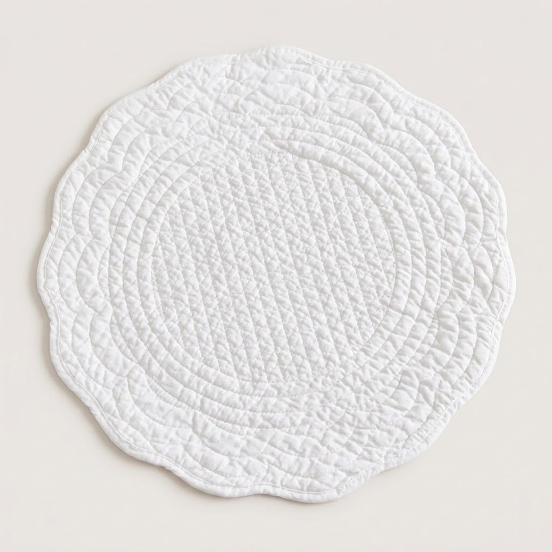 A round white quilted placemat with a scalloped edge, shown flat against a light beige background.