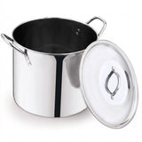 A stainless steel stockpot with a matching glass lid leaning against it, shown on a clean white background.